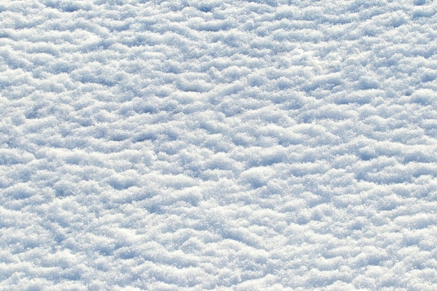 Fundo de inverno, textura de neve em tempo ensolarado