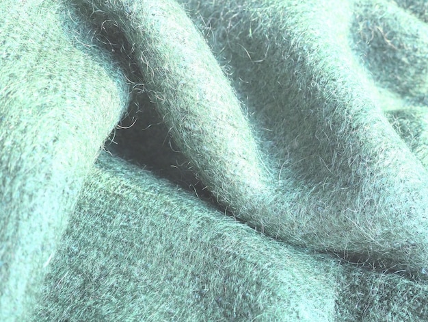 Fundo de lã tricotada Roupas quentes de inverno amarradas da marca de fios verdes Angora Uma pilha desgrenhada Uma amostra de tricô Fio dobrado