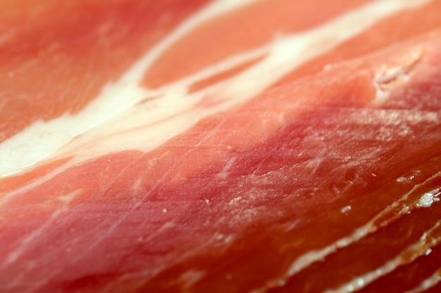 Fundo de mercearia de carne cortando jamon