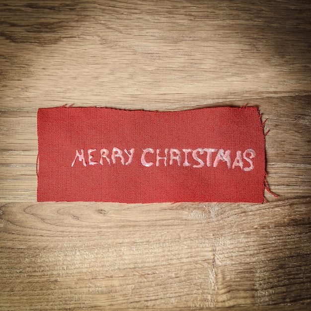 Fundo de natal a inscrição feliz natal em madeira