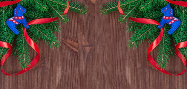 Foto fundo de natal com ramos de abeto e decorações em um fundo de madeira marrom