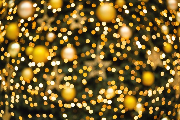 Foto fundo de natal desfocado com luzes brilhantes fundo de bokeh dourado conceito de holdays