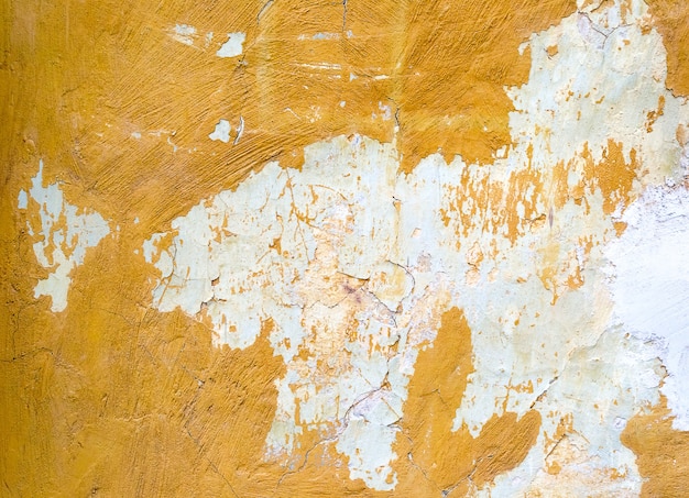 Fundo de parede de concreto pintado de amarelo rachado