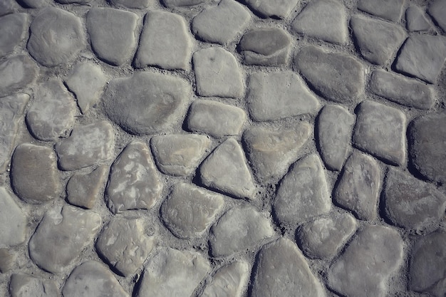 fundo de pavimento de pedra antigo / pavimento abstrato, paralelepípedos grandes, textura de estrada velha