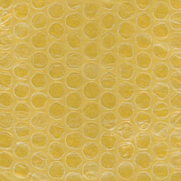 Fundo de plástico e papel com textura de plástico bolha amarelo