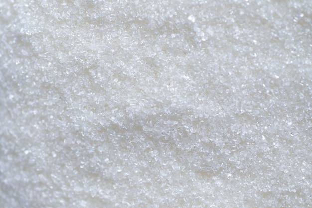 Fundo de textura de açúcar açúcar branco para alimentos e doces pilha de doces de sobremesa de açúcar cristalino granulado