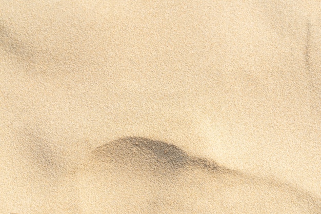 Foto fundo de textura de areia. padrão de deserto marrom de praia tropical. fechar-se.
