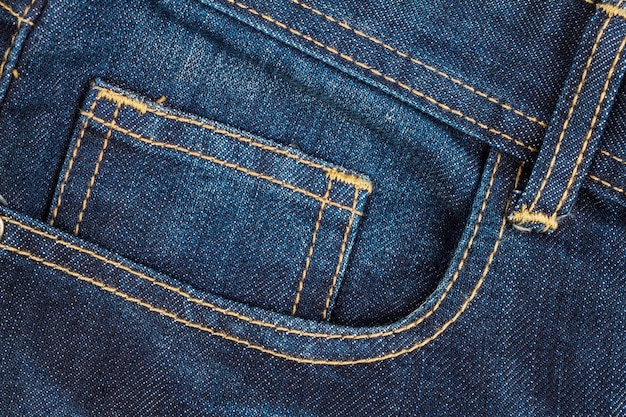 Fundo de textura de bolso de calça jeans azul, closeup