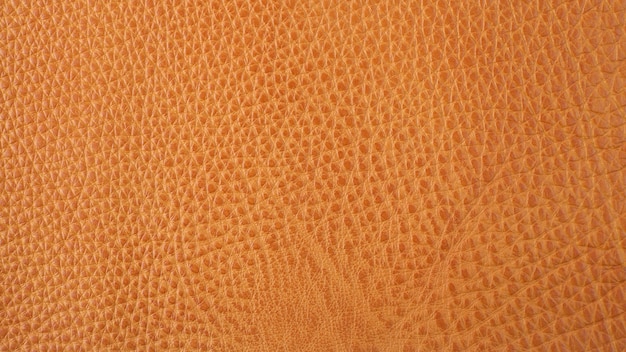 Fundo de textura de couro de gado laranja genuíno. com cicatrizes. foto macro