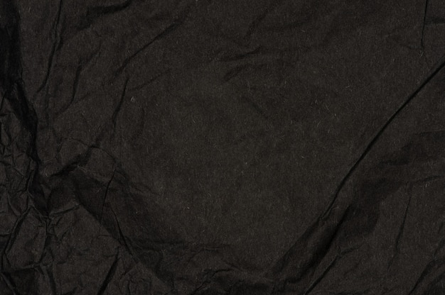 Foto fundo de textura de papel amassado preto. copie o espaço no design.