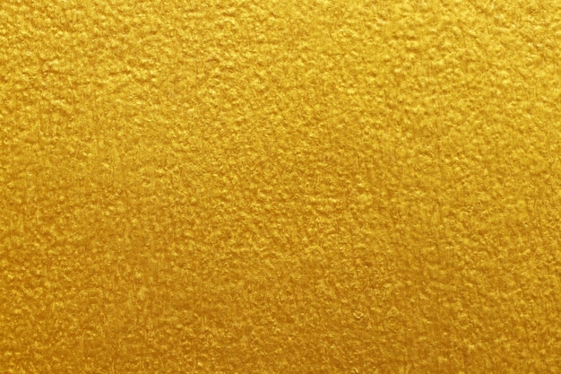 Fundo de textura de parede de concreto de cimento dourado com estuque áspero e velho grunge.