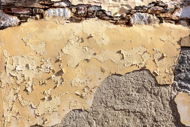Fundo de textura de parede de pedra envelhecida Estrutura de parede de pedra áspera descascada e desgastada antiga