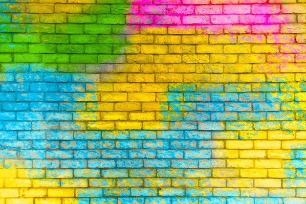 Foto fundo de textura de parede de tijolos pintados coloridos graffiti parede de tijolos de fundo colorido