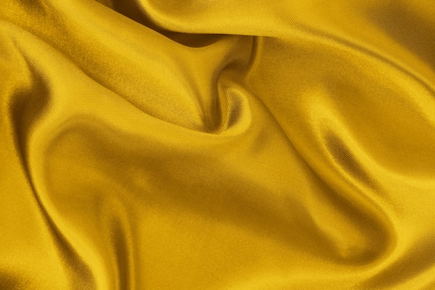 Fundo de textura de tecido amarelo dourado amassado padrão de seda ou linho