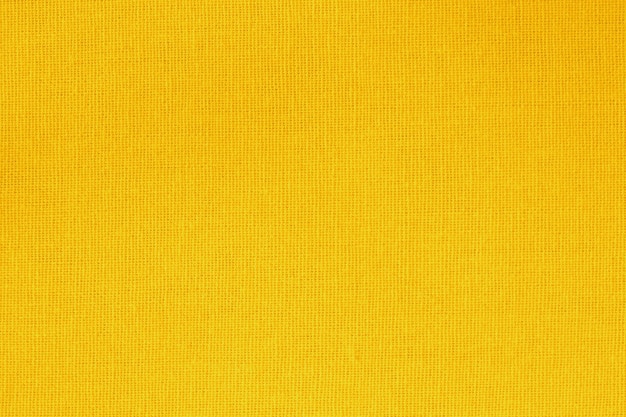 Fundo de textura de tecido de algodão amarelo dourado com padrão sem emenda.