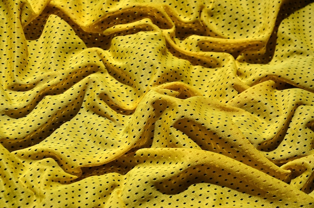 Fundo de textura de tecido de roupa esporte amarelo