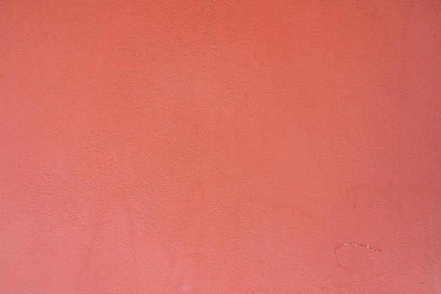 Fundo de um padrão de parede de pedra rosa coberta com gesso decorativo