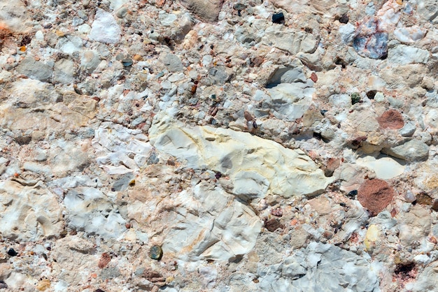 Fundo de um velho muro de pedra feito de pequenas pedras