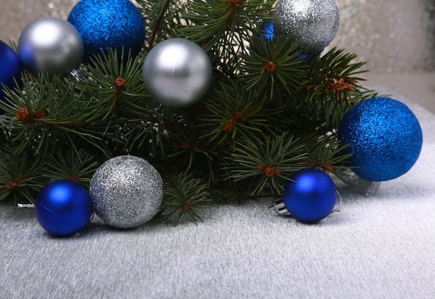 Fundo decorativo de Natal com galhos de pinheiro e bolas vermelhas na prata