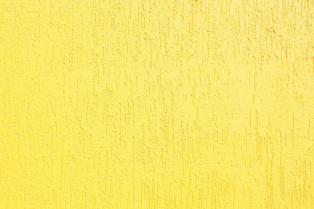 Fundo e textura da parede de estuque texturizado amarelo.