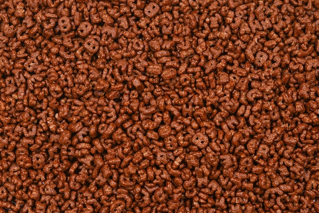 Fundo e textura de flocos de milho. Vista do topo. caixa de cereais cornflake para o café da manhã.