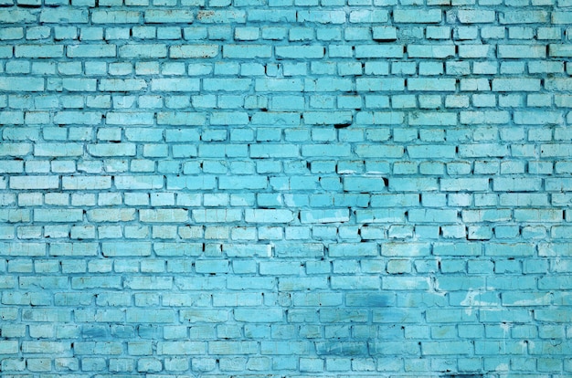 Fundo e textura quadrados da parede do bloco do tijolo. Pintado em azul