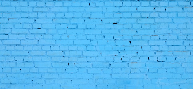 Fundo e textura quadrados da parede do bloco do tijolo. Pintado em azul