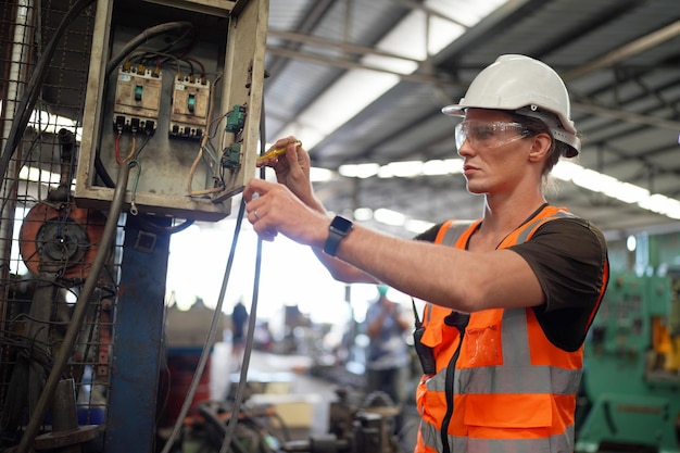 Fundo industrial de engenheiro mecânico caucasiano operando máquina de torno para metalurgia em fábrica de metalurgia