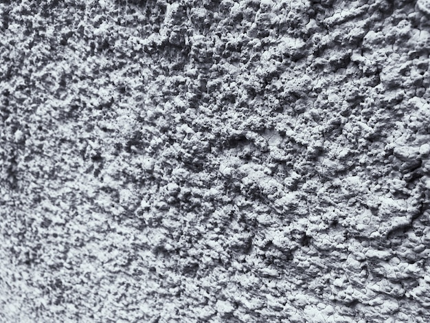 Fundo resistido e sujo da textura do muro de cimento em preto e branco.
