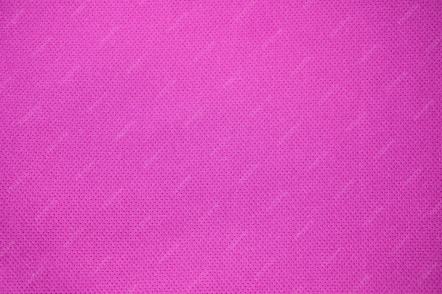 Fundo textured tela cor-de-rosa. camisa de tecido de roupas rosa de