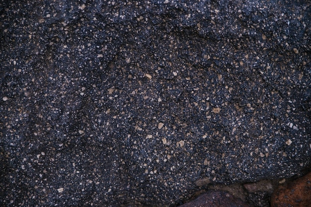 Fundo texturizado de pedra preta Pedra natural O fundo preto é um espaço em branco para o design Superfície irregular