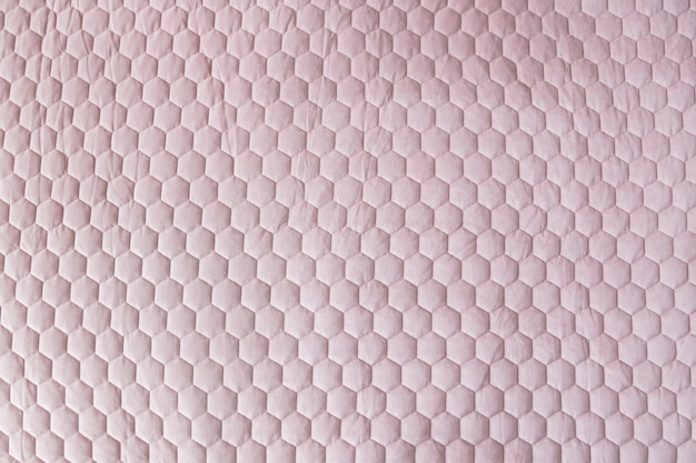 Fundo texturizado de tecido de malha hexagonal de cor rosa