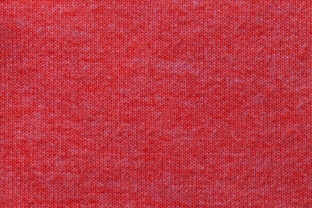 Fundo vermelho escuro de um material têxtil. Tecido com textura natural. Pano de fundo.