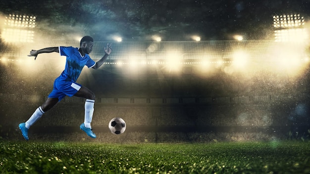 Fußballspieler in blauer Uniform sprinten schnell mit dem Ball im Stadion