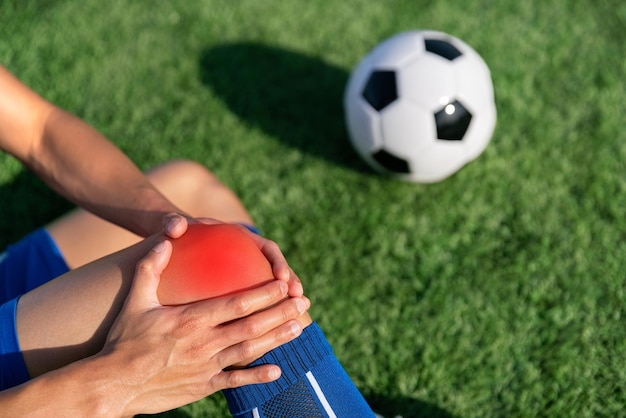 futebol jogador de futebol acidente lesão no joelho tratamento esportivo em partida de futebol no estádio de futebol