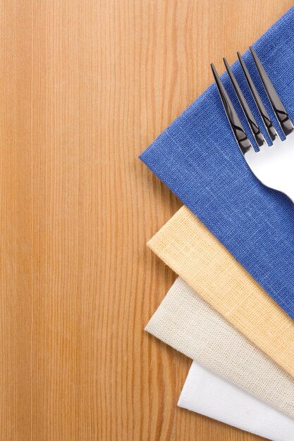 Gabel und Messer als Utensilien auf Serviette auf Holztisch