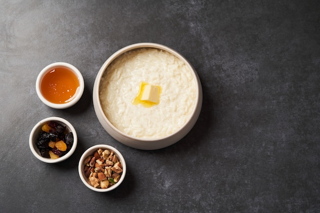 Gachas de arroz con leche, pasas, miel y nueces en un tazón.