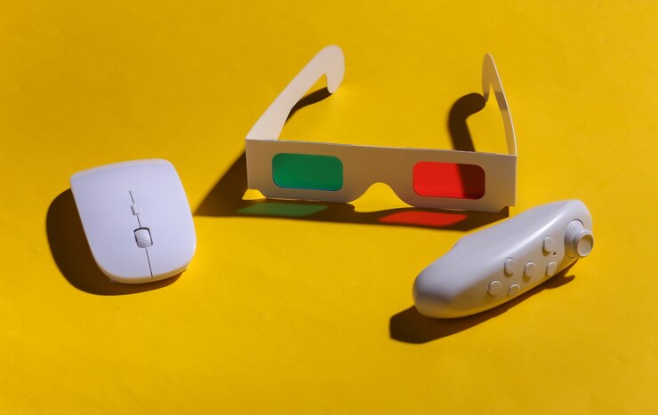 Foto gafas 3d anaglifo, mouse de pc y joystick sobre fondo amarillo con una sombra. arte pop.
