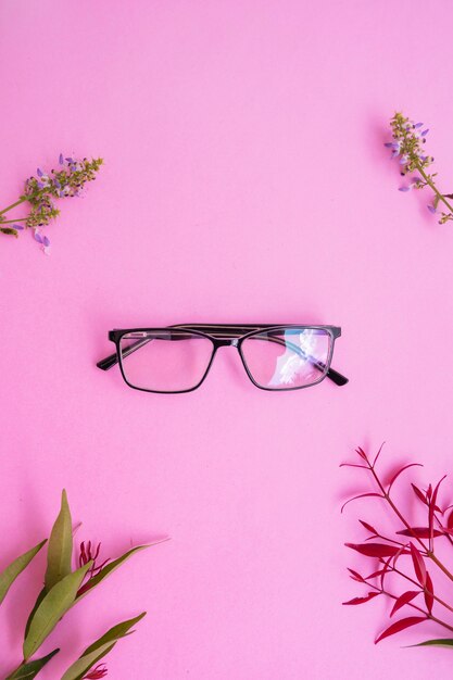 Gafas cuadradas en la foto de estilo minimalista veraniego sobre un fondo rosa pastel.