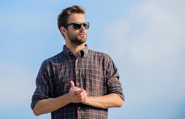 Gafas de sol de moda Modelo de gafas de hombre al aire libre Fondo de cielo azul Concepto de protección ultravioleta Visión perfecta Véalo claro Chico guapo usa gafas de sol Hombre hipster en gafas de sol de moda