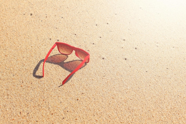 Foto gafas de sol rojas en la playa