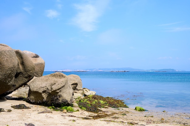 Galizischer Strand mit Felsen und blauem Himmel. Naturhintergrund.