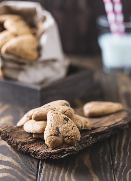 Galletas de chocolate en la mesa rústica de madera. Galletas de chispas de chocolate en forma de corazón. Galletas caseras