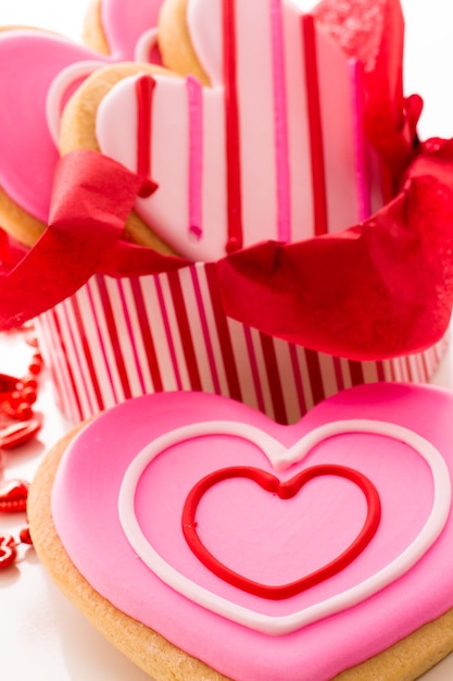 Galletas en forma de corazón decoradas con elegantes patrones de glaseado.