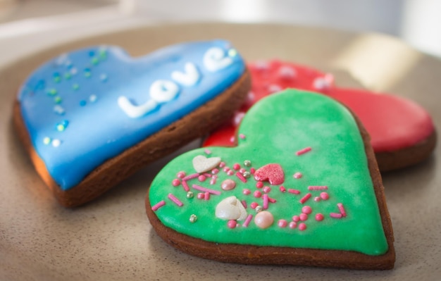 Galletas de jengibre en forma de corazón. Tres galletas dulces con palabra amor. Decoración del día de San Valentín.