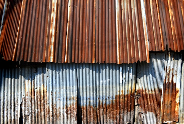 Galvanizado viejo y oxidado en la textura y el color de la casa pobre del pasado