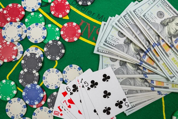 Gamble Poker conceptplaying cards chips y dólares están dispersos alrededor de la nueva mesa de póquer