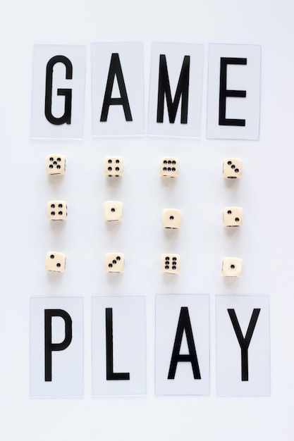 Foto game play-wörter und gaming-würfel in reihe auf weißem hintergrund draufsicht