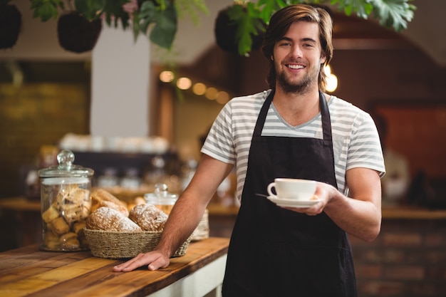 garçom, oferecendo uma xícara de café