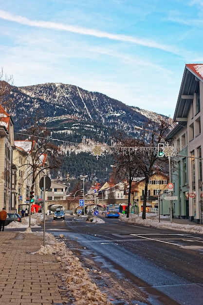 Garmisch-Partenkirchen, Deutschland - 6. Januar 2015: Straße mit Häusern im bayerischen Stil und Alpenbergen im Winter Altstadt von Garmisch Partenkirchen in Deutschland. Menschen im Hintergrund